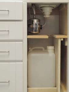 Fabricated and installed under sink shelf, cabinet partition, gray water tank mount