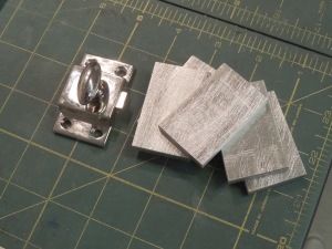 Machined spacers for cabinet door latches
